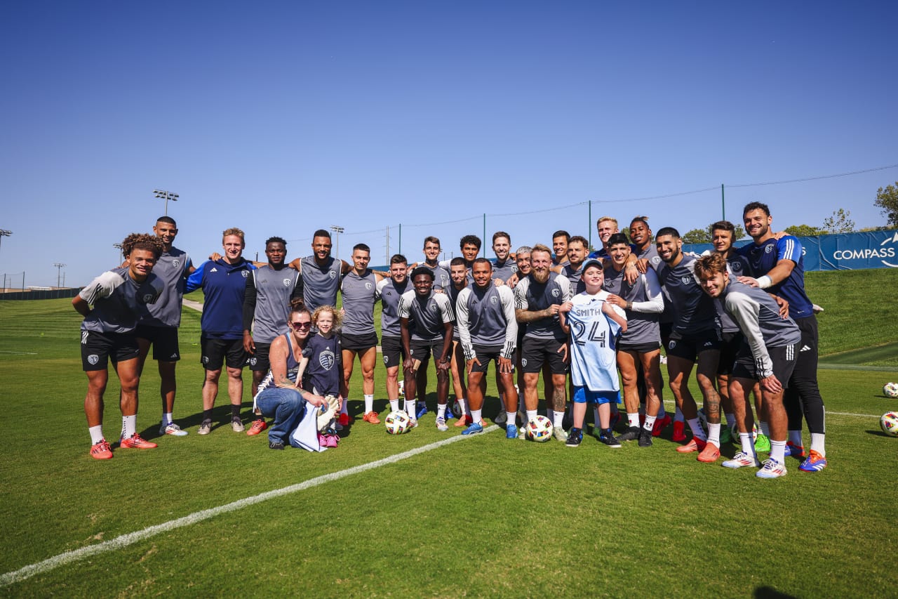 The team takes a photo with Miles after training.