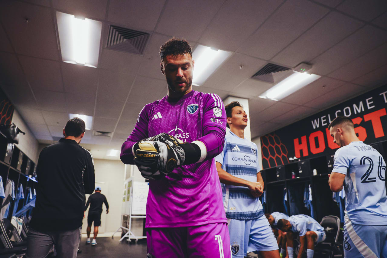 Sporting KC goalkeeper John Pulskamp puts his gloves on before the game vs Houston