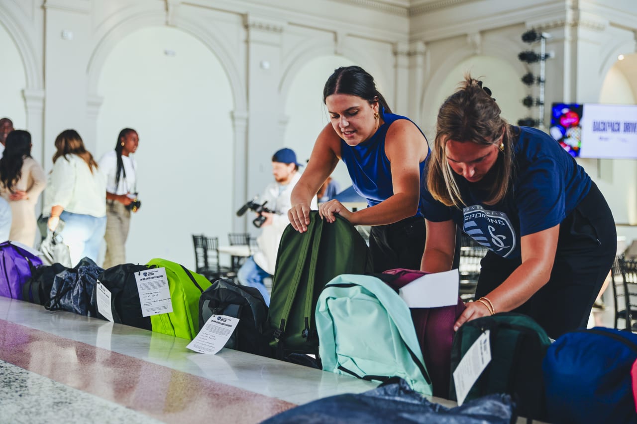 Sporting KC Associates ensure the backpacks are ready for delivery.