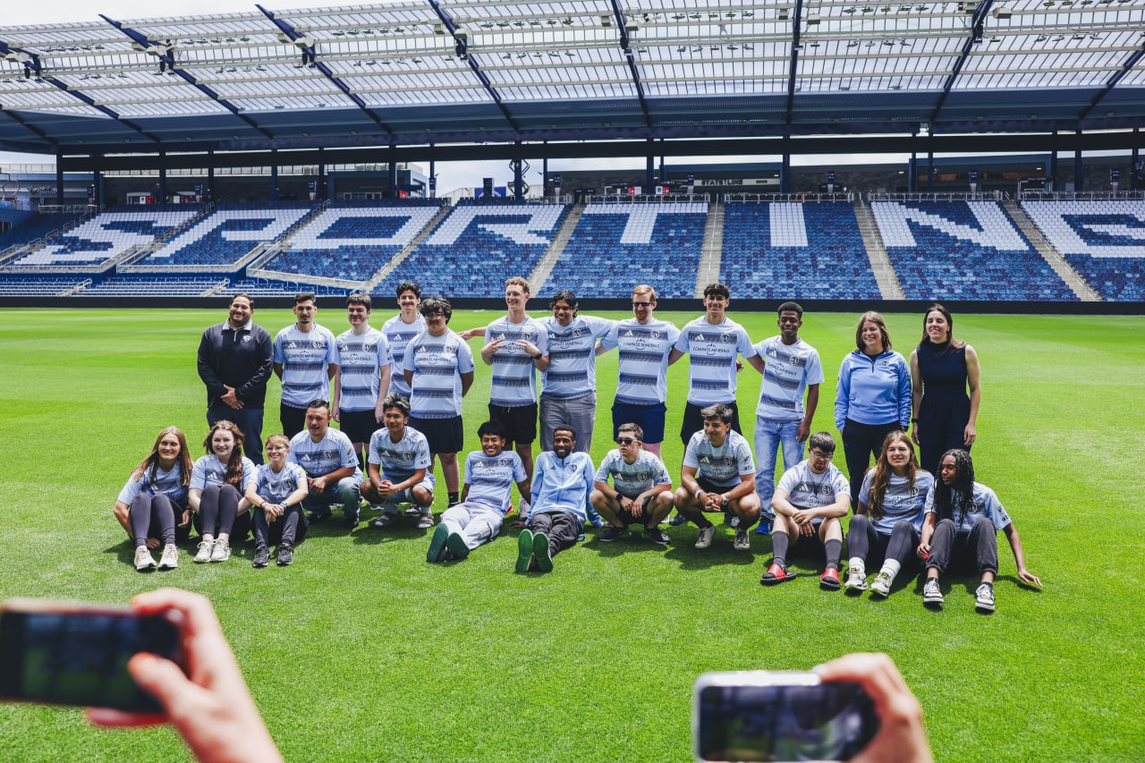 Unified team and coaches poses for a team photo at Children's Mercy Park on signing day.