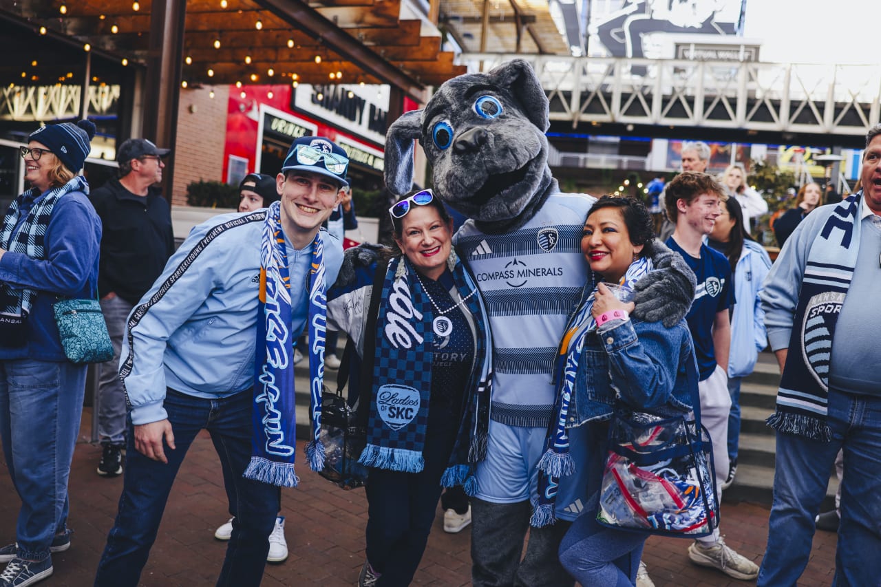A group of fans get a photo with Blue