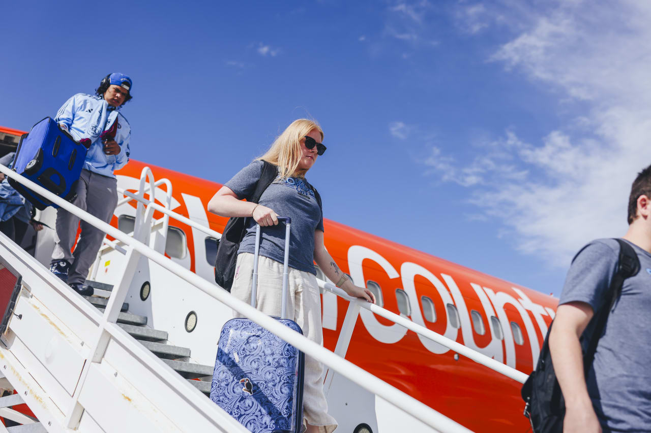 Valerie Fry departs the SKC charter flight in Salt Lake.