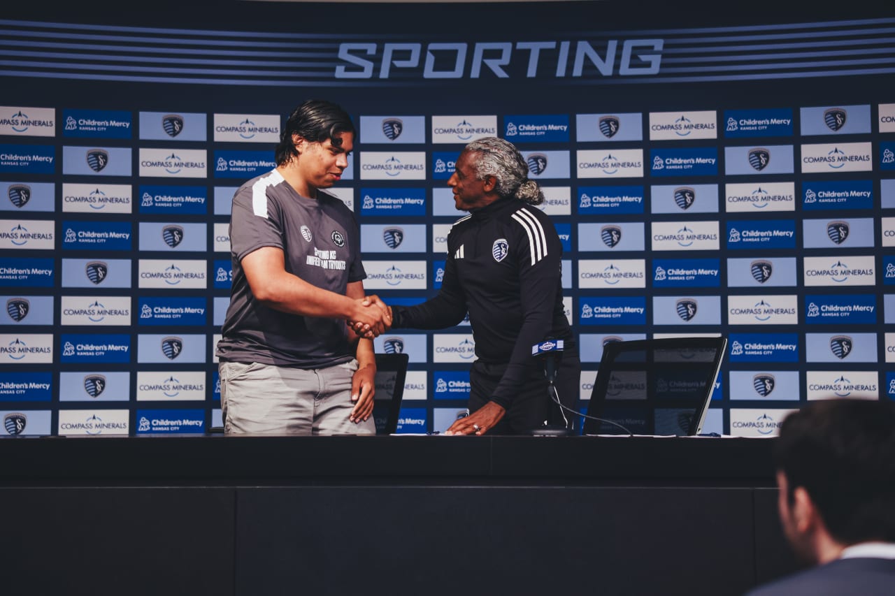 Unified player Antonio Romero shakes Academy Director Declan Jogi's hand after signing his agreement