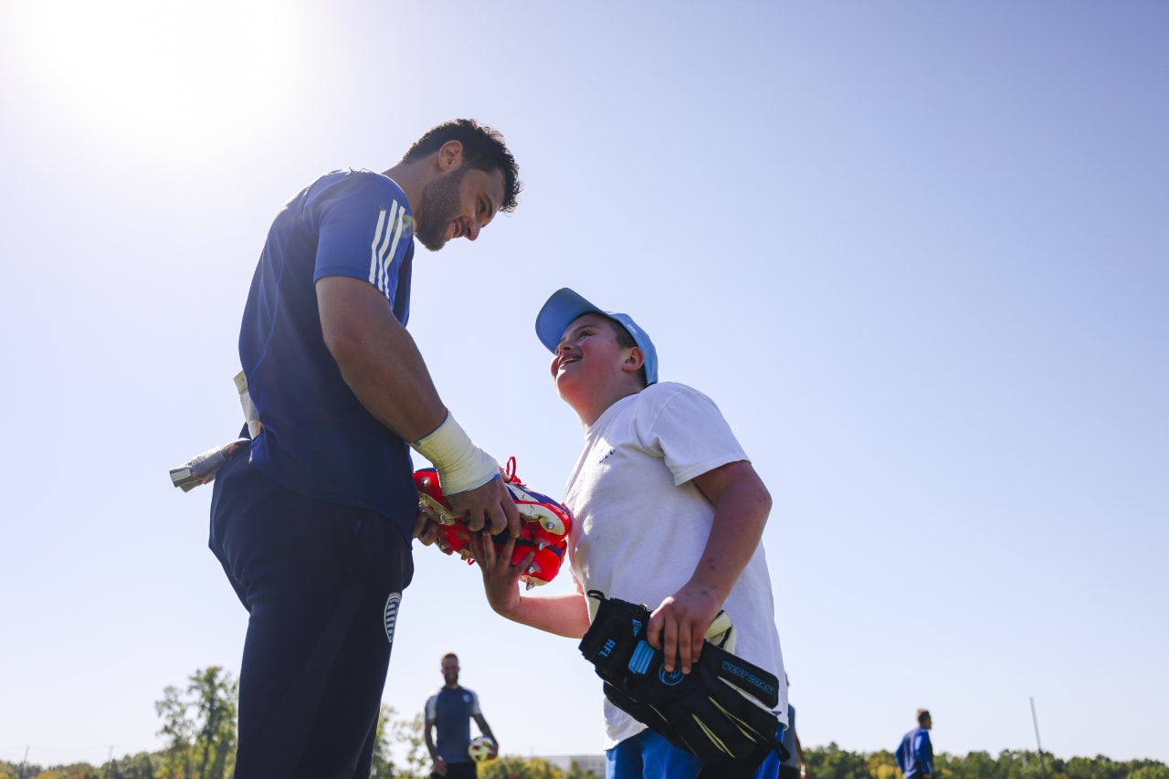John Pulskmap gifts Miles Smith his boots post training.