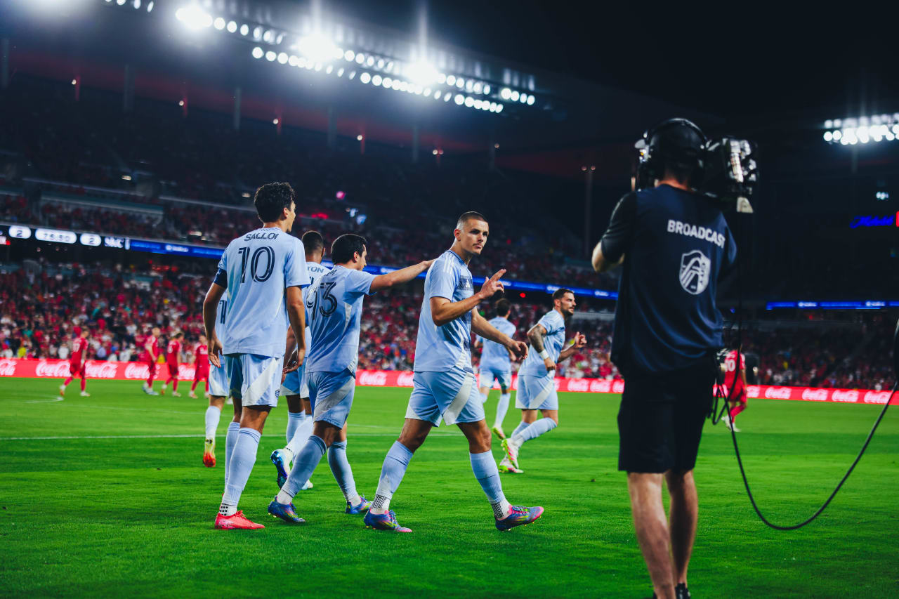 Sporting KC forward Dejan Joveljic does his finger gun celebration while walking back after scoring