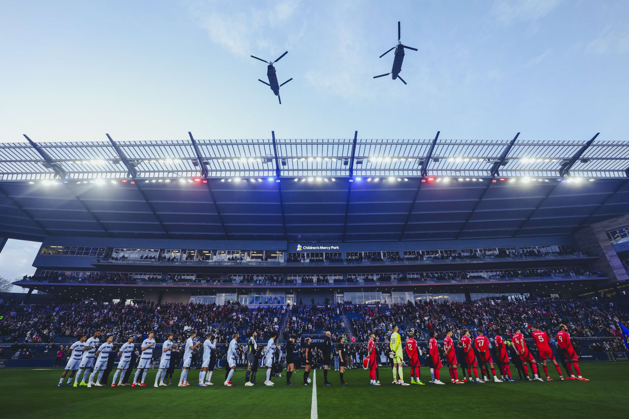 Two helicopters fly over Children's Mercy Park as the players stand for the National Anthem.