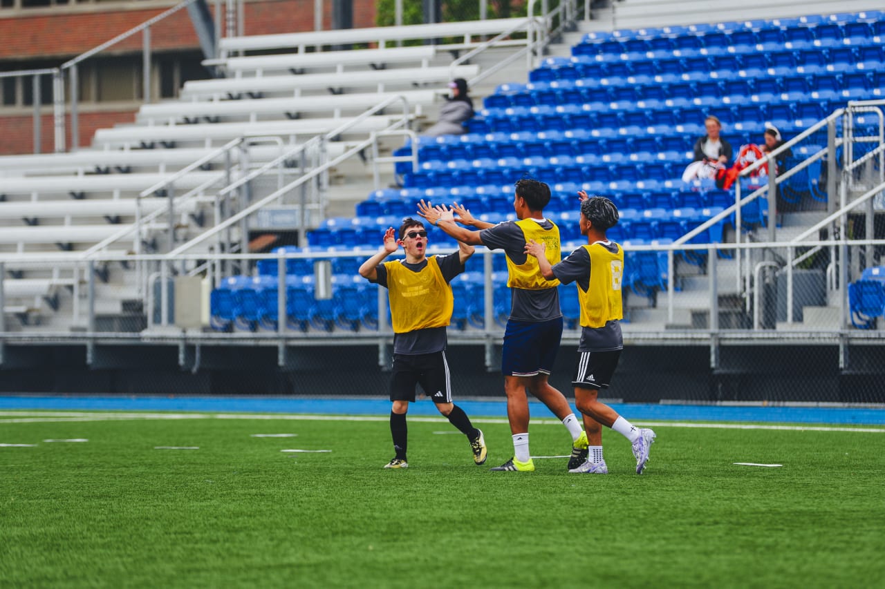 Players celebrate a goal at Sporting KC's Unified Team tryouts on April 27.