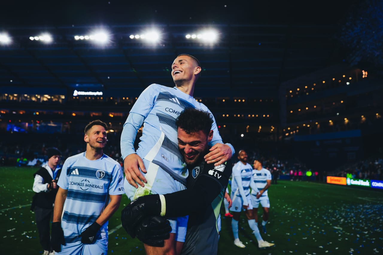 Sporting KC goalkeeper John Pulskamp hoists forward Dejan Joveljic up in the air after defeating rival St. Louis