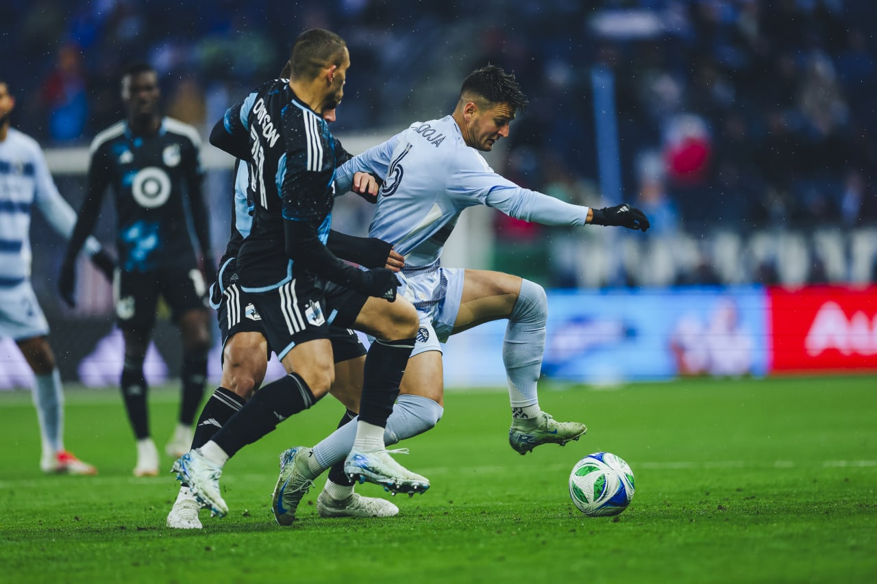 Sporting KC midfielder Nemanja Radoja fights to keep control of the ball.