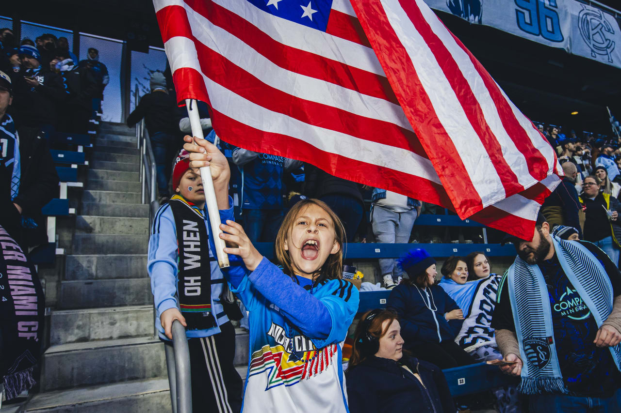 A young Sporting KC fan waves an American flag during the game on Saturday.