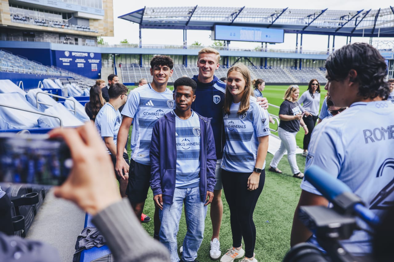 Unified players stand for a photo with Sporting KC goalkeeper Ryan Schewe