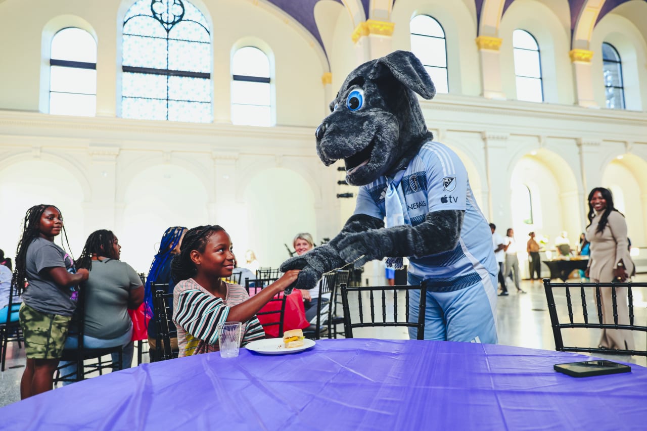 Sporting KC Mascot Blue, meets students during the Backpack Drive delivery on