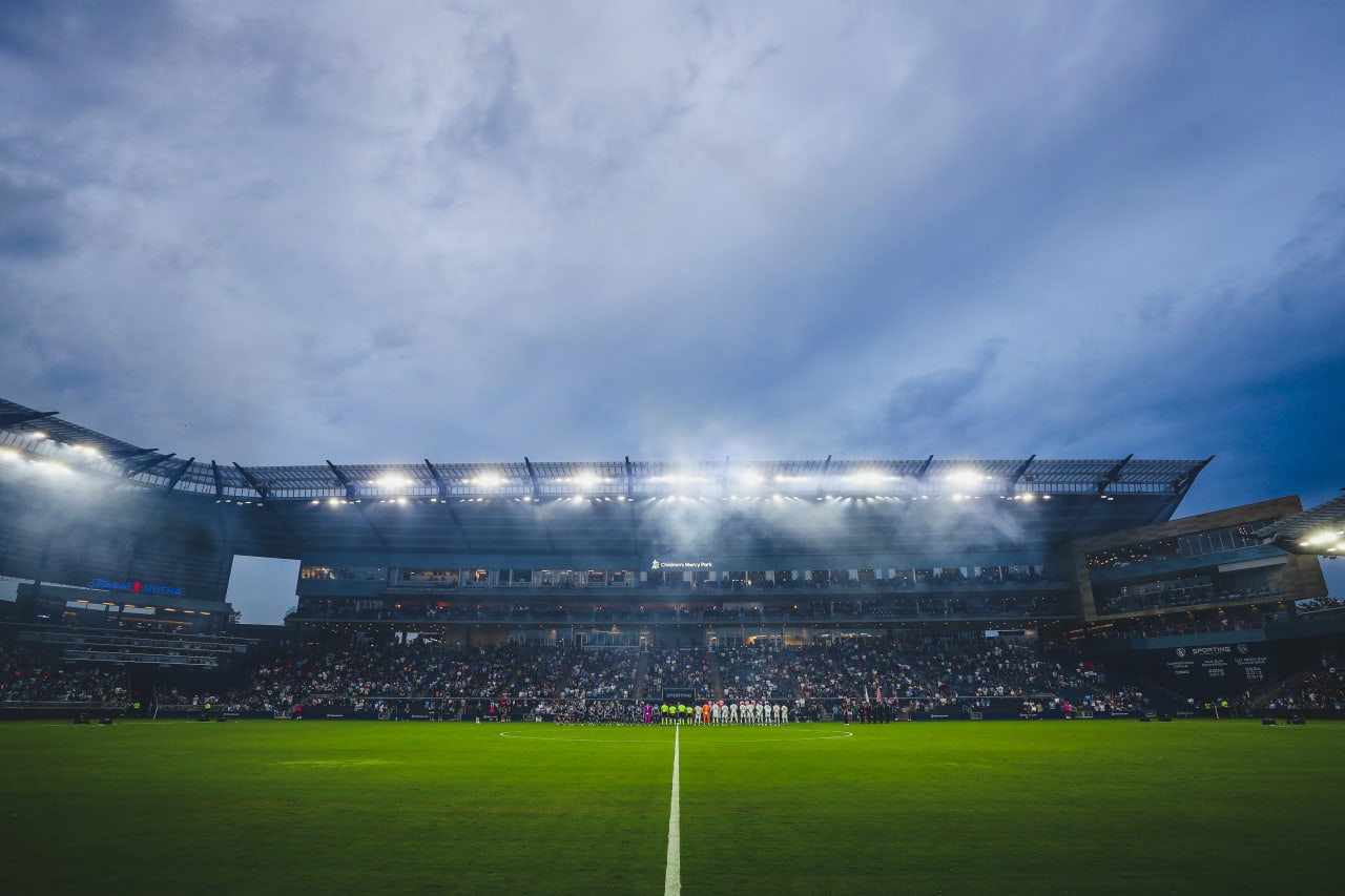 Both teams stand for the national anthem before the game at Chldren's Mercy Park.
