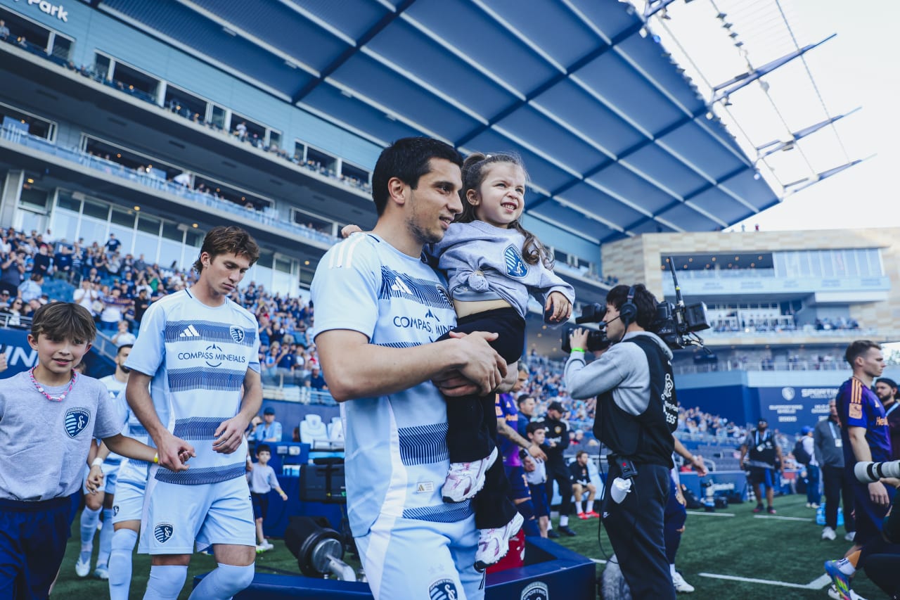 Sporting KC forward Shapi Suleymanov walks out with his daughter pregame.