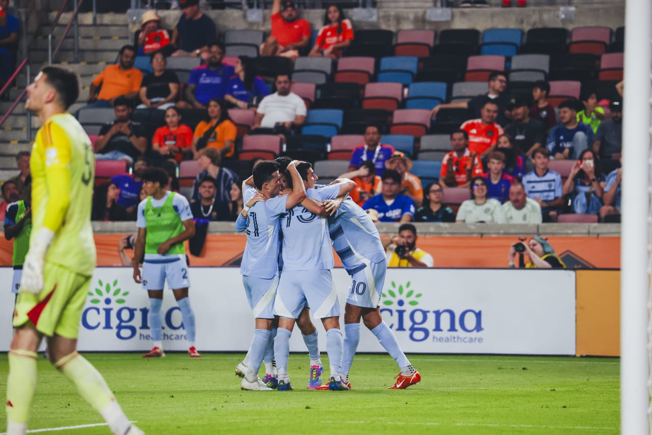 Sporting KC forward Santiago Munoz celebrates with the team after scoring his first goal with Sporting KC