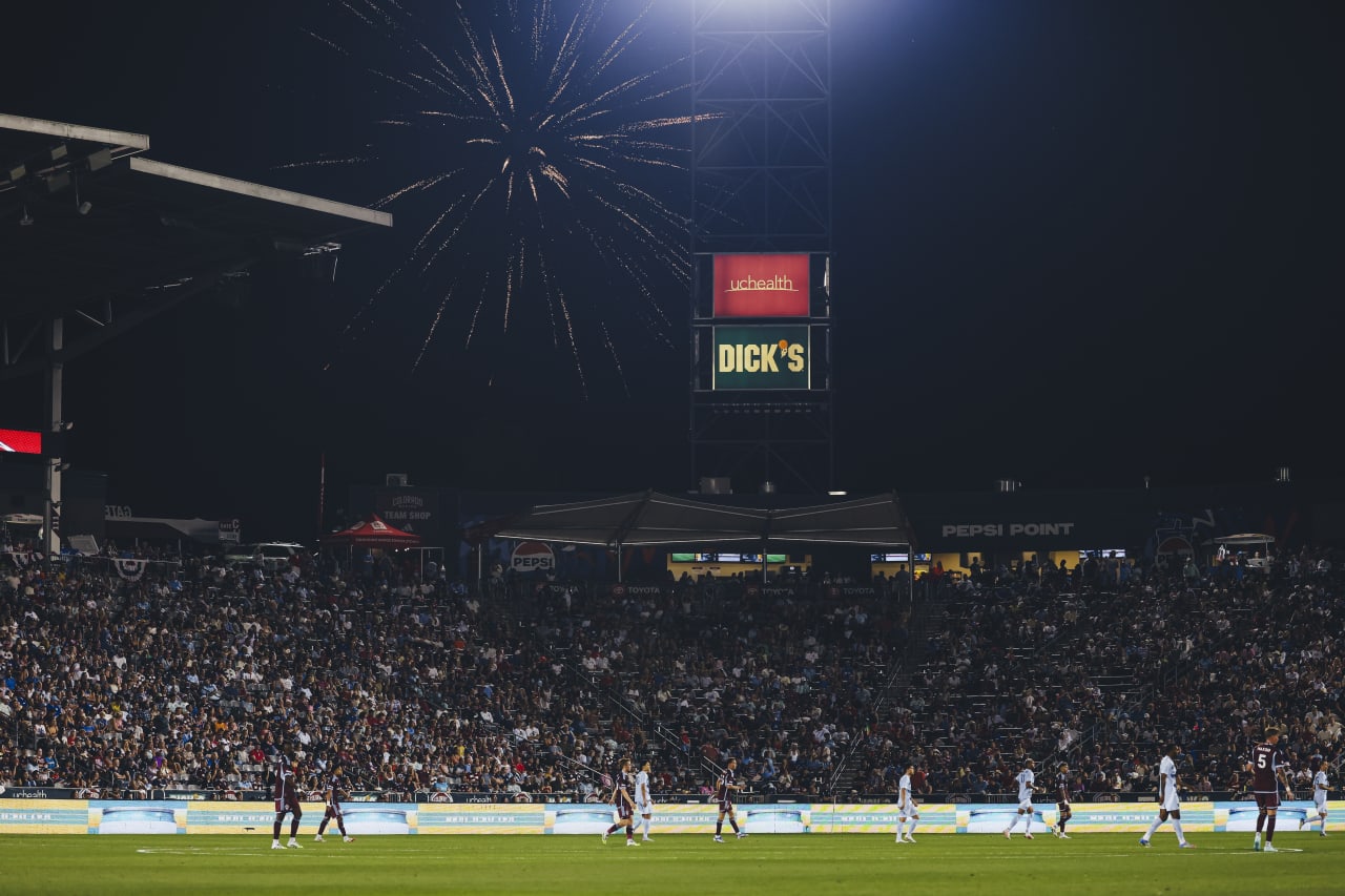 A firework explodes outside the stadium during the game on the 4th