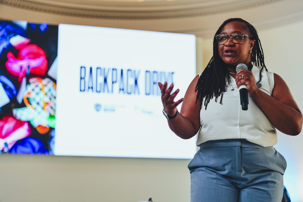 Sporting KC Community Impact Manager, Maigan Bridgette welcomes students to the Adopt a Backpack Drive.