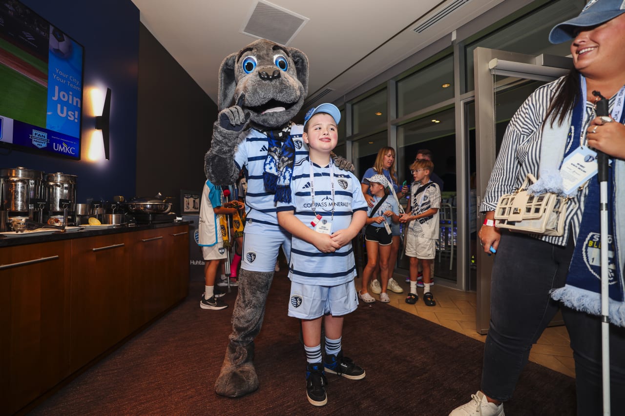 Miles takes a picture with Blue in the Victory Suite.