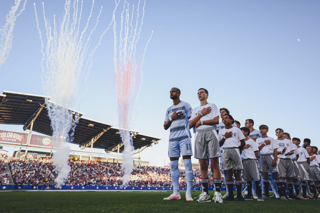 Sporting KC defender Khiry Shelton stands for the National Anthem as fireworks explode behind him