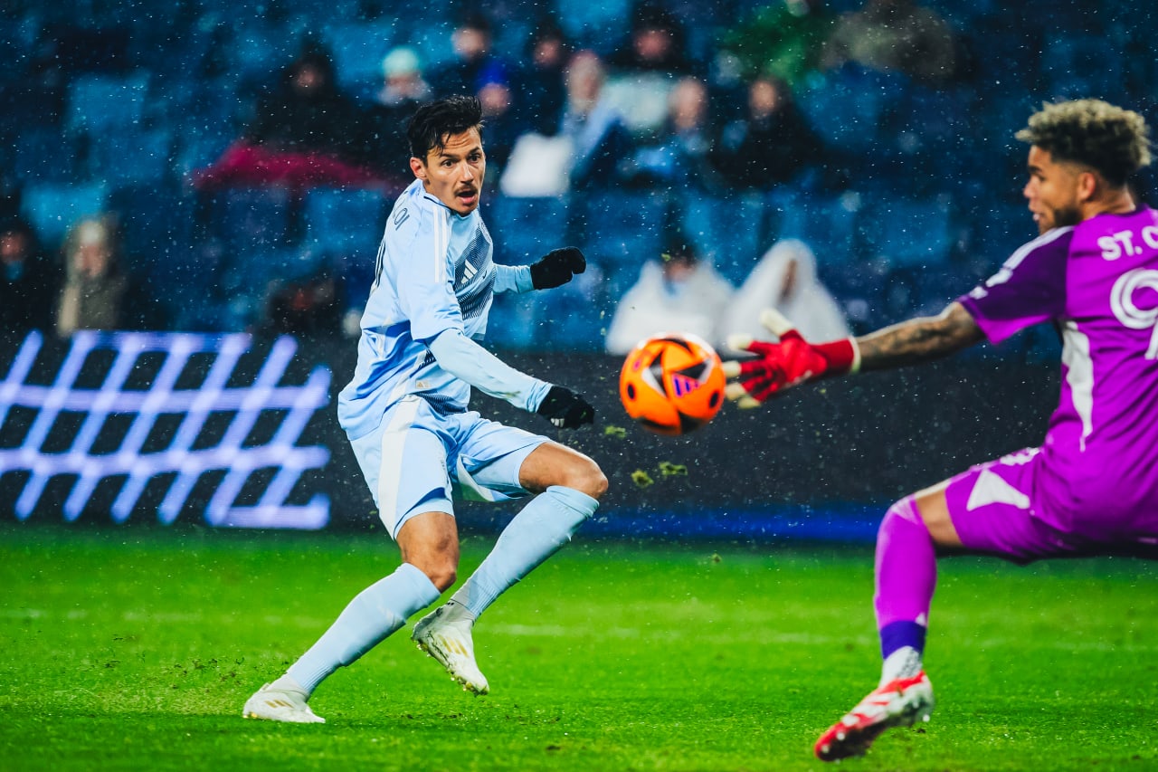 Sporting KC winger Daniel Salloi chips the ball past the Minnesota keeper.