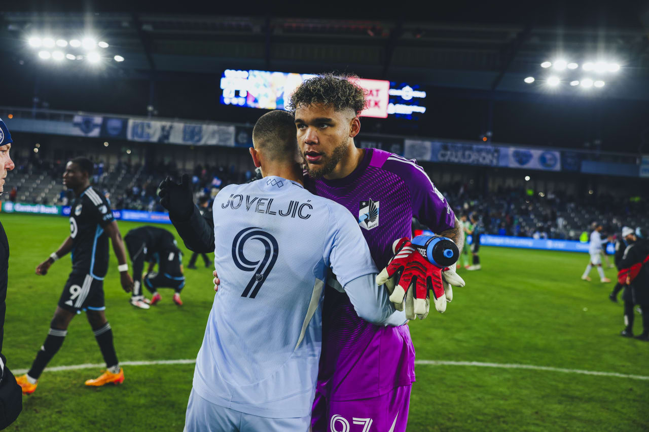 Sporting KC forward Dejan Joveljic shares respect with Minnesota United keeper Dayne St. Clair after the game.