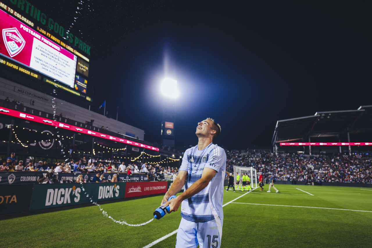 Sporting KC defender sprays water at the Sporting KC fans after beating the Rapids