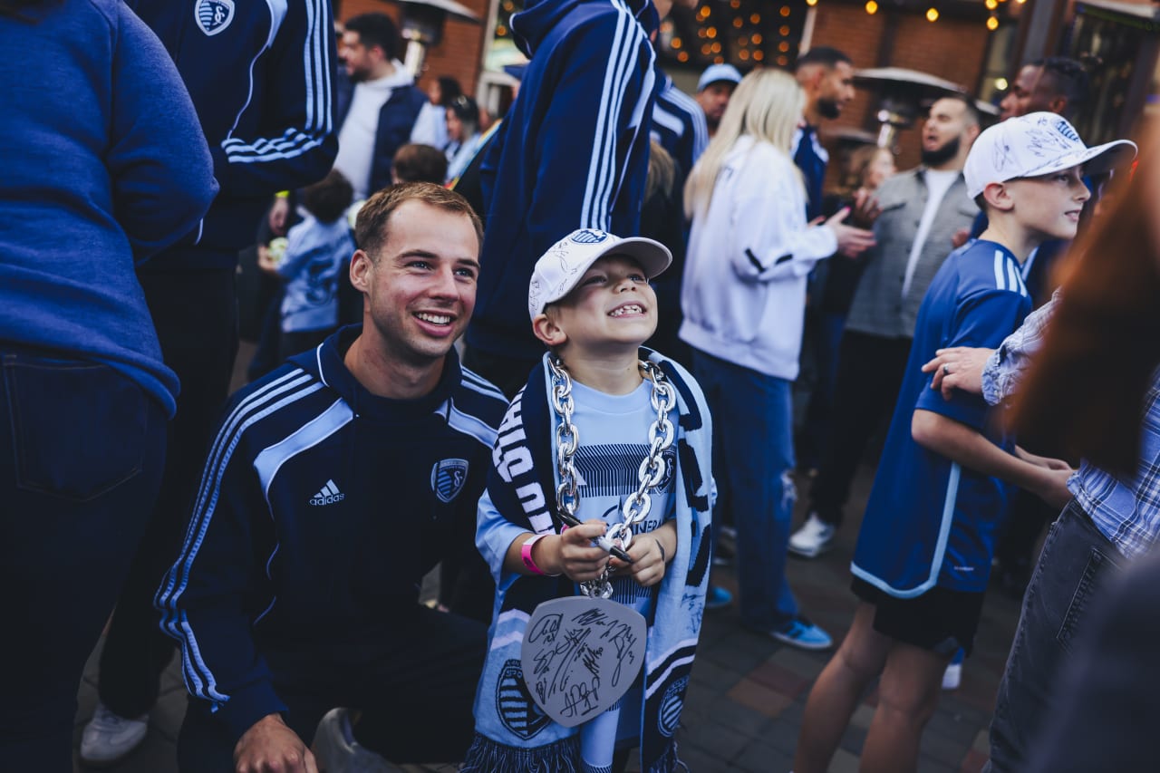 Sporting KC defender Jansen Miller takes a photo with a young fan