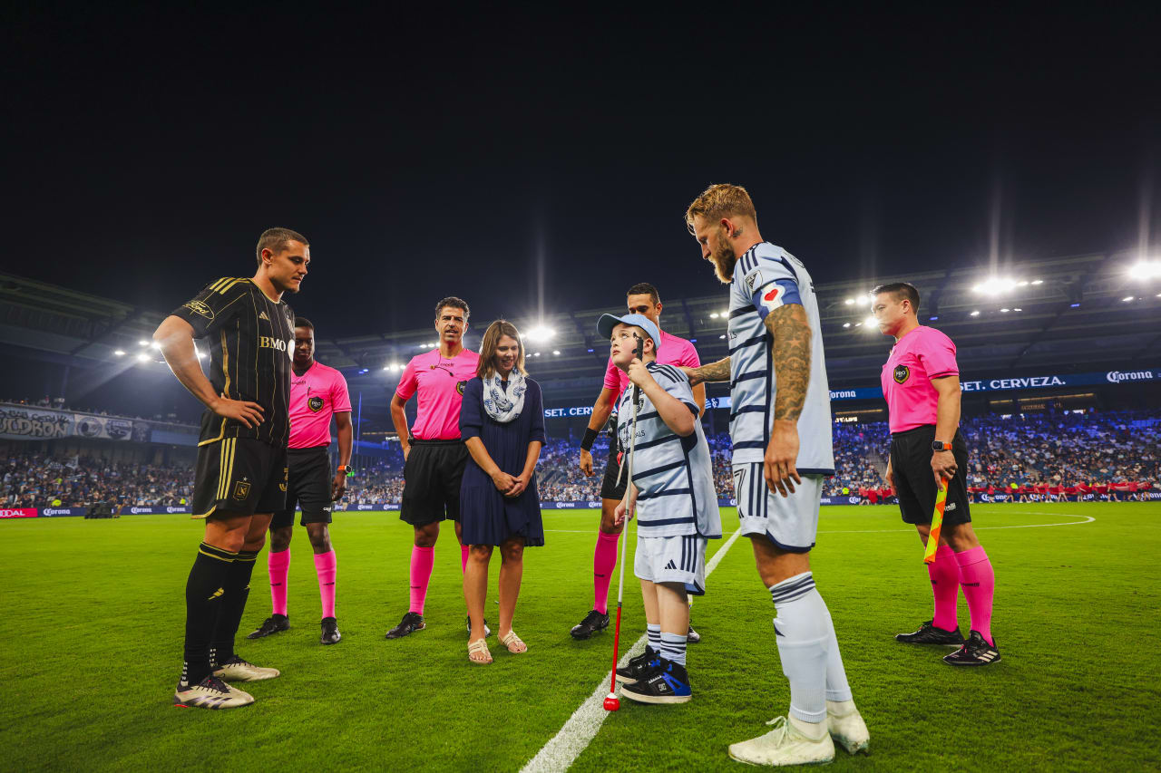 Miles does the coin toss during the Oct. 5 match.