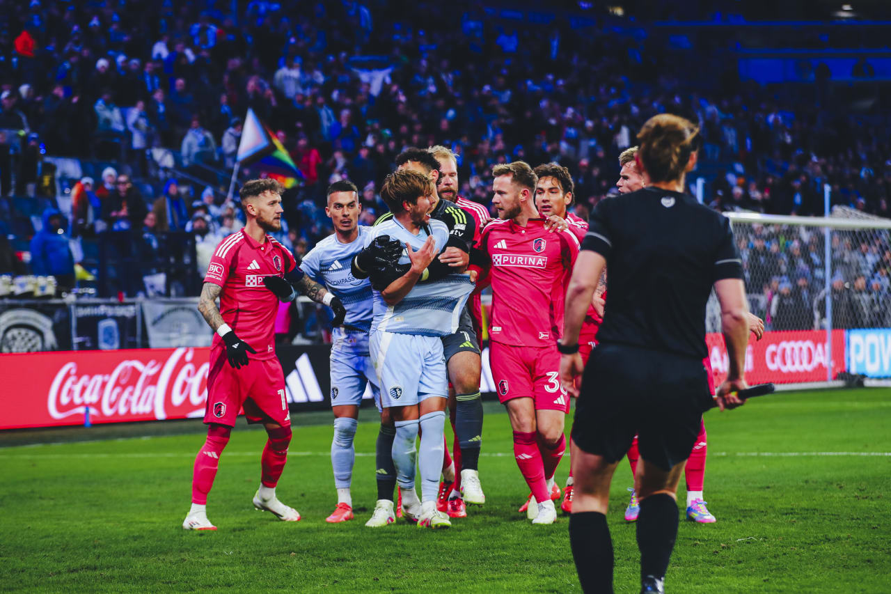 Sporting KC goalkeeper John Pulskamp holds Jake Davis back from oncoming St. Louis players after the game.