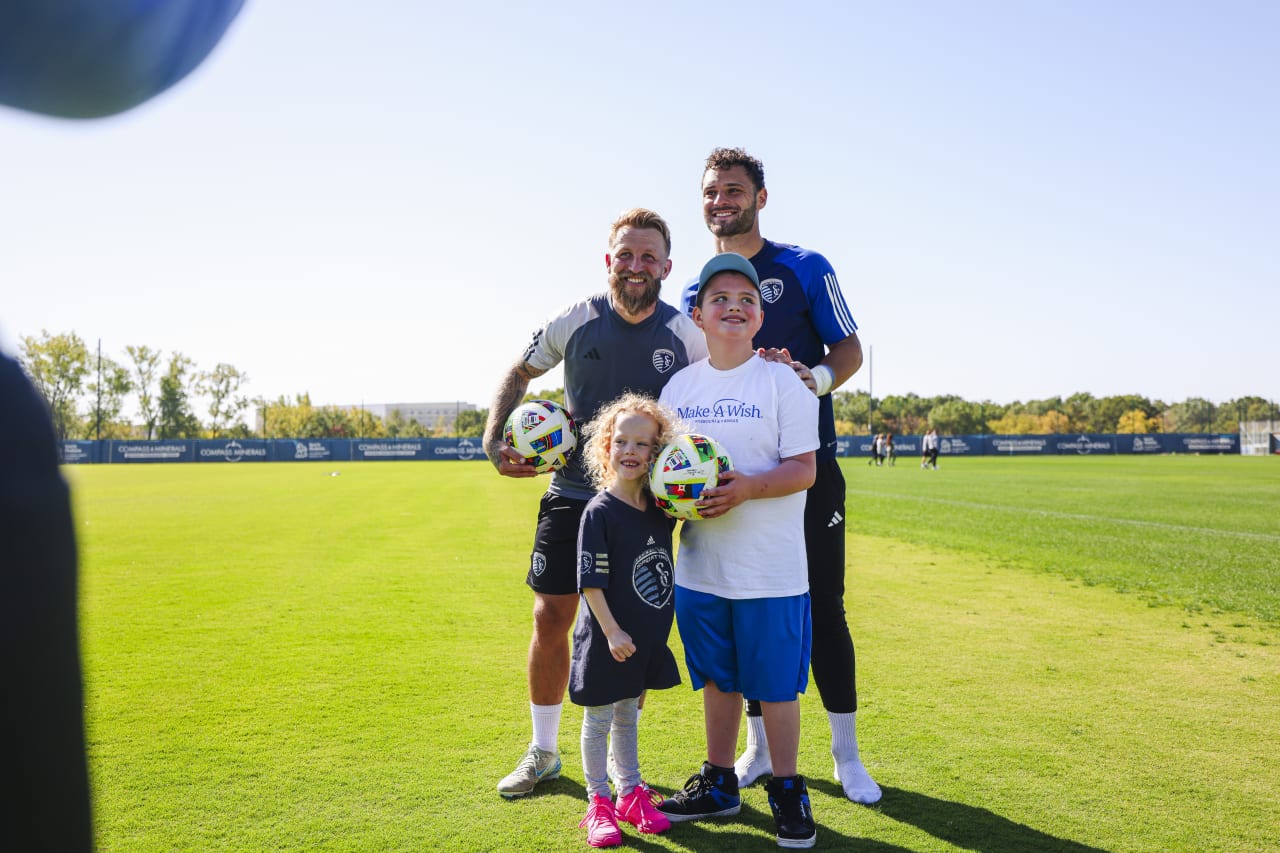 Johnny Russell and John Pulskamp take a photo with Miles and his sister Penelope.