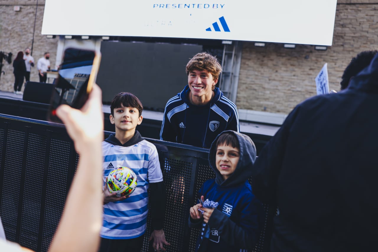 Sporting KC midfielder Jacob Bartlett stops to pose for a photo with two young Sporting KC fans