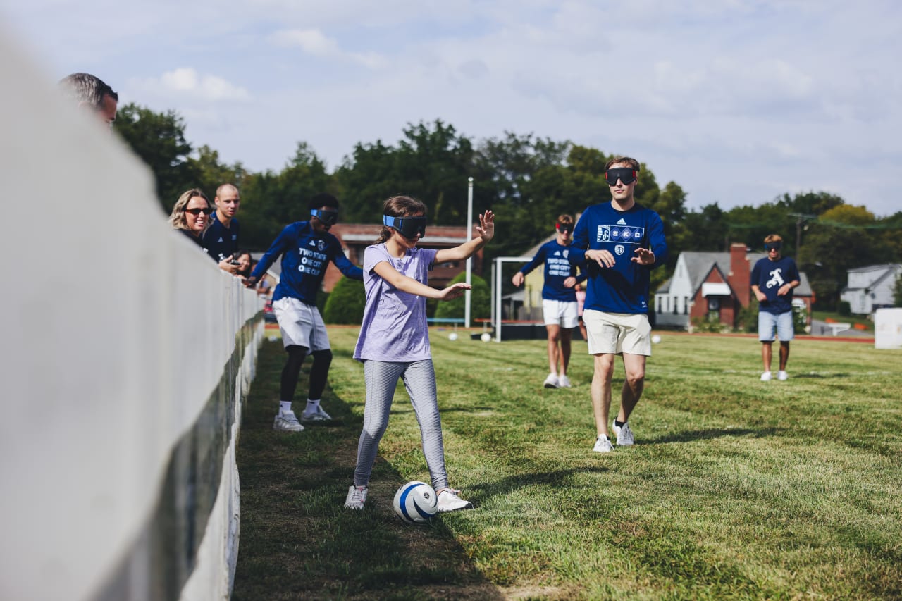 A KSSB blind soccer athlete dribbles the ball in a game of blind soccer.