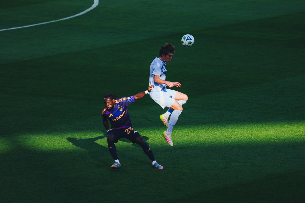 Sporting KC midfielder Jacob Bartlett wins a header vs LA forward Joseph Paintsil.