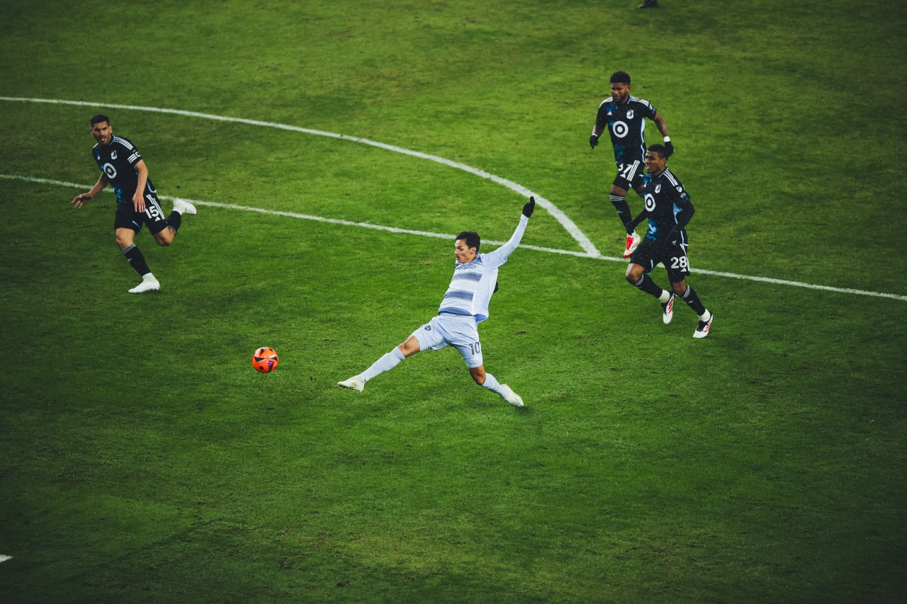 Sporting KC winger Daniel Salloi stretches to chip the ball into the goal.