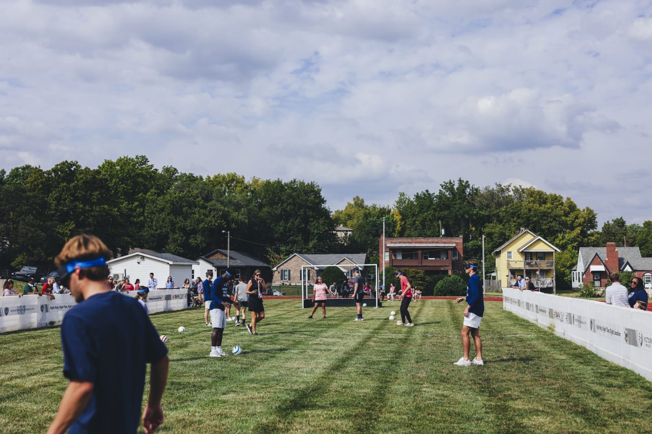 Sporting KC players and KSSB blind soccer athletes work on passing while blindfolded.