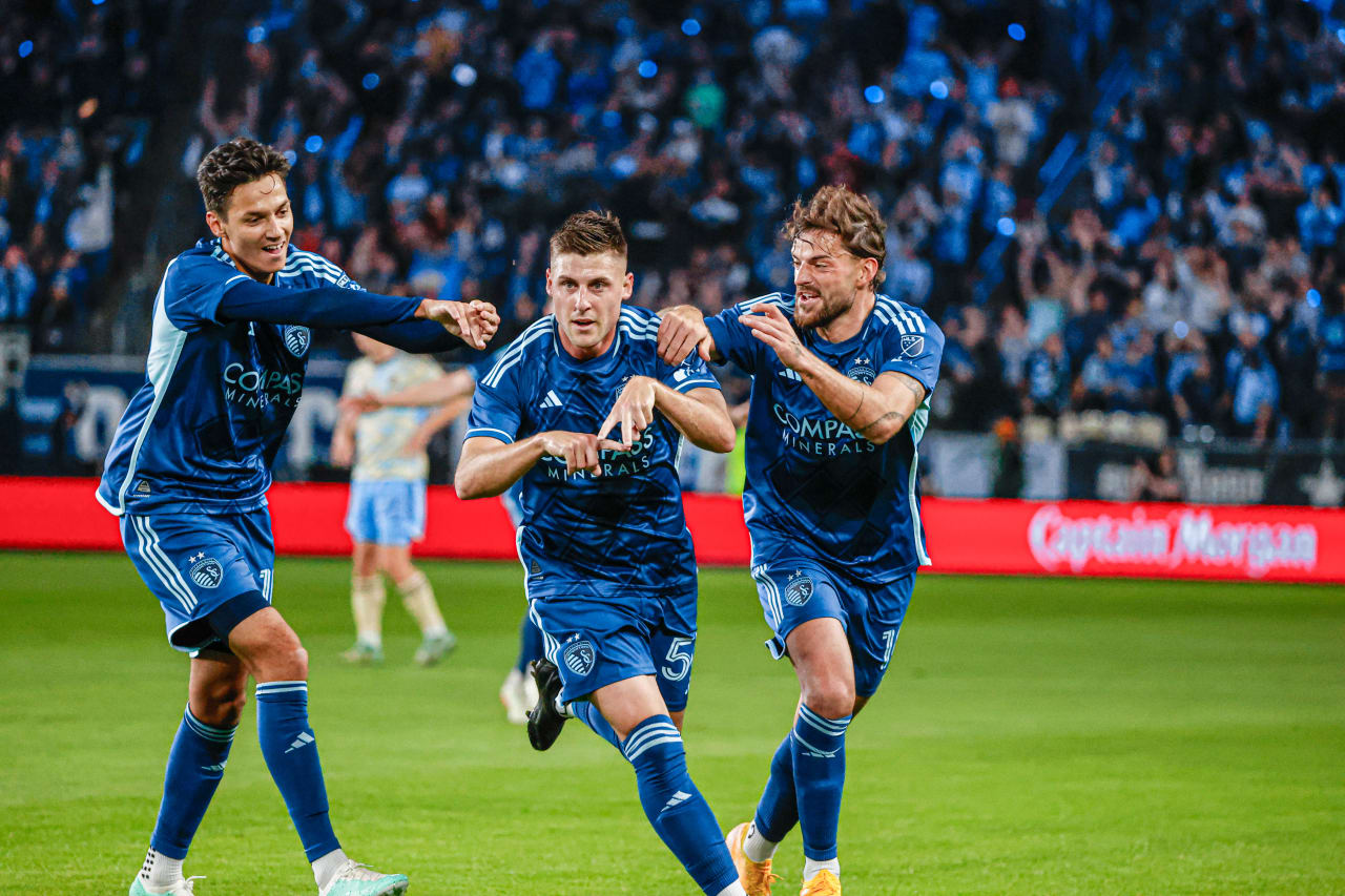Midfielder Rémi Walter (54) celebrates his goal making an "A" with hand as his teammates Daniel Salloi (10) and Tim Leibold (14) cheer him on during the SKC vs Philadelphia Union match on March 2, 2024.