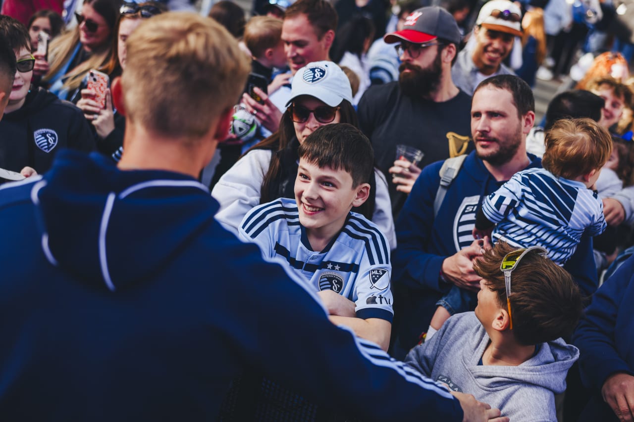 A young Sporting KC fan smiles as he meets Sporting KC goalkeeper Ryan Schewe