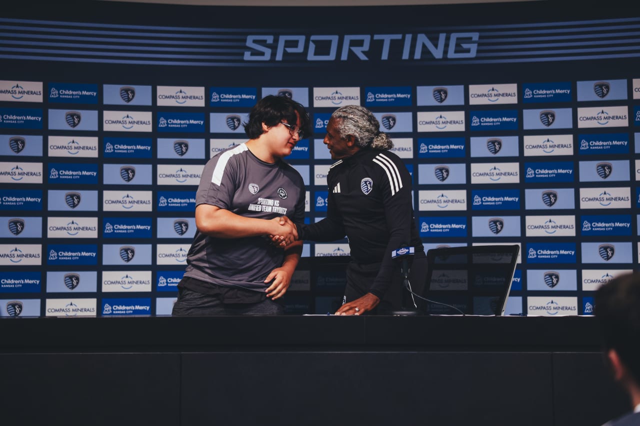 Unified player Tyler Robonel shakes Academy Director Declan Jogi's hand after signing his agreement