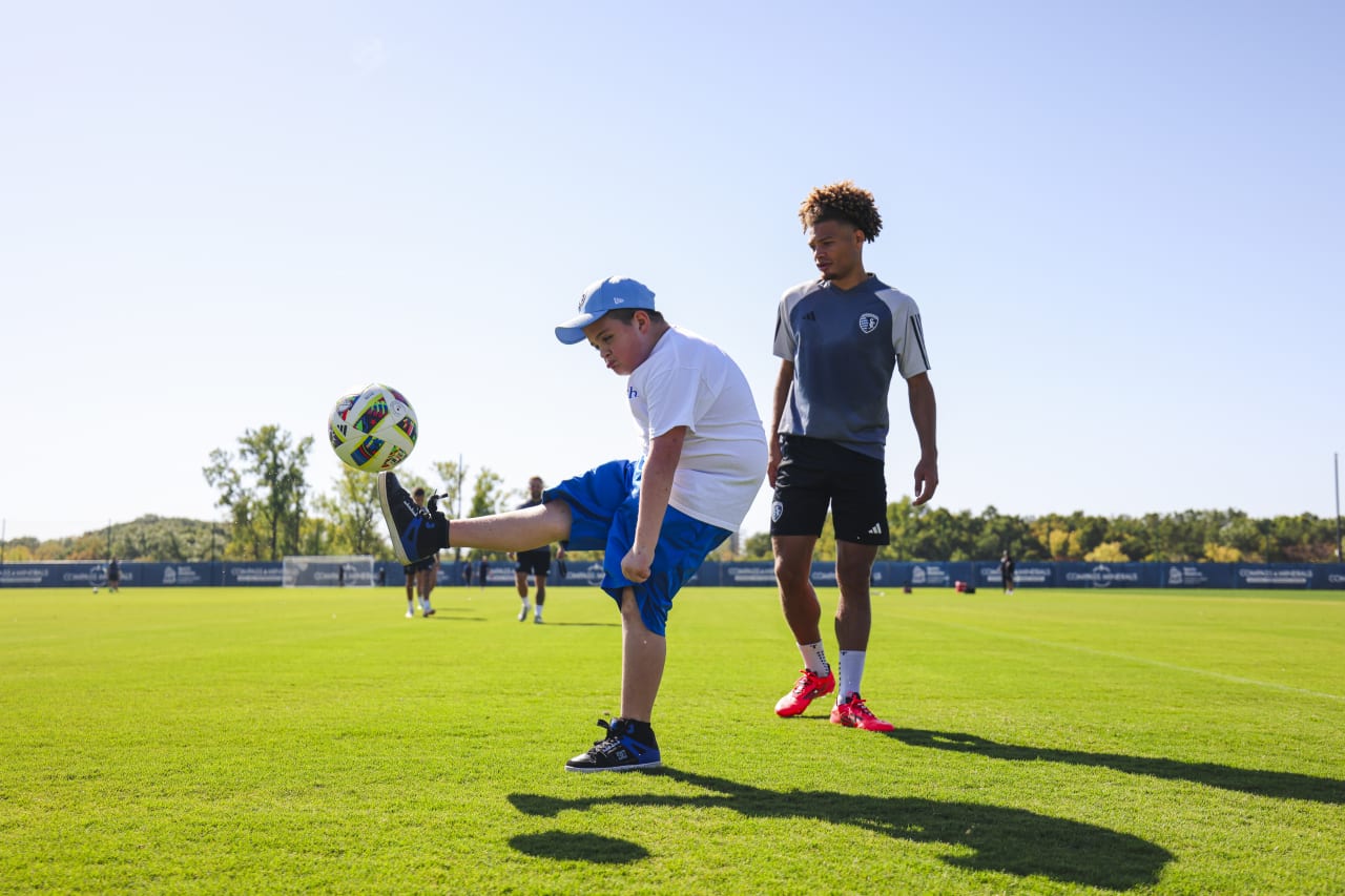 Miles shows off his soccer skills in front of Zorhan Bassong.