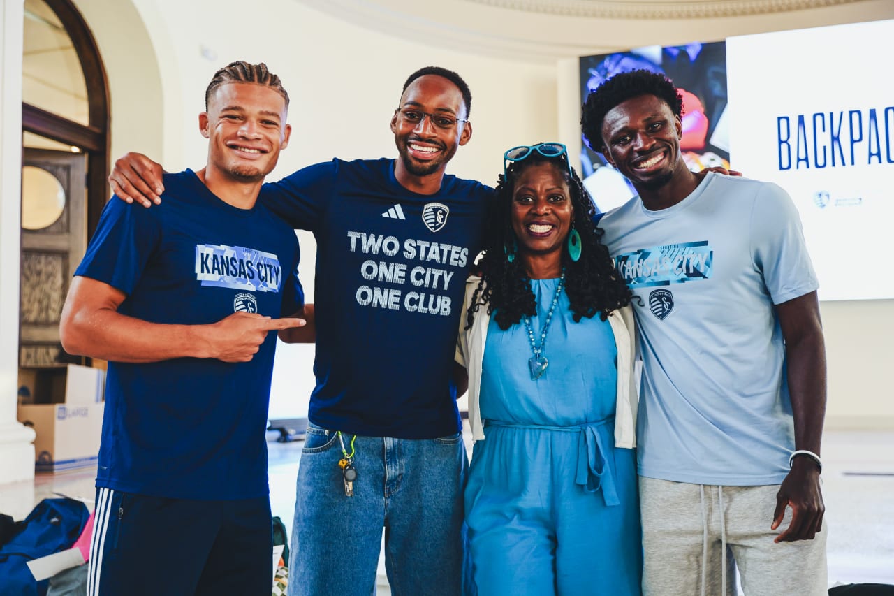 Sporting KC players Mason Toye, Zorhan Bassong and Stephen Afrifa take a picture with Angie Daniels, Hope Center KC Senior Program Manager.