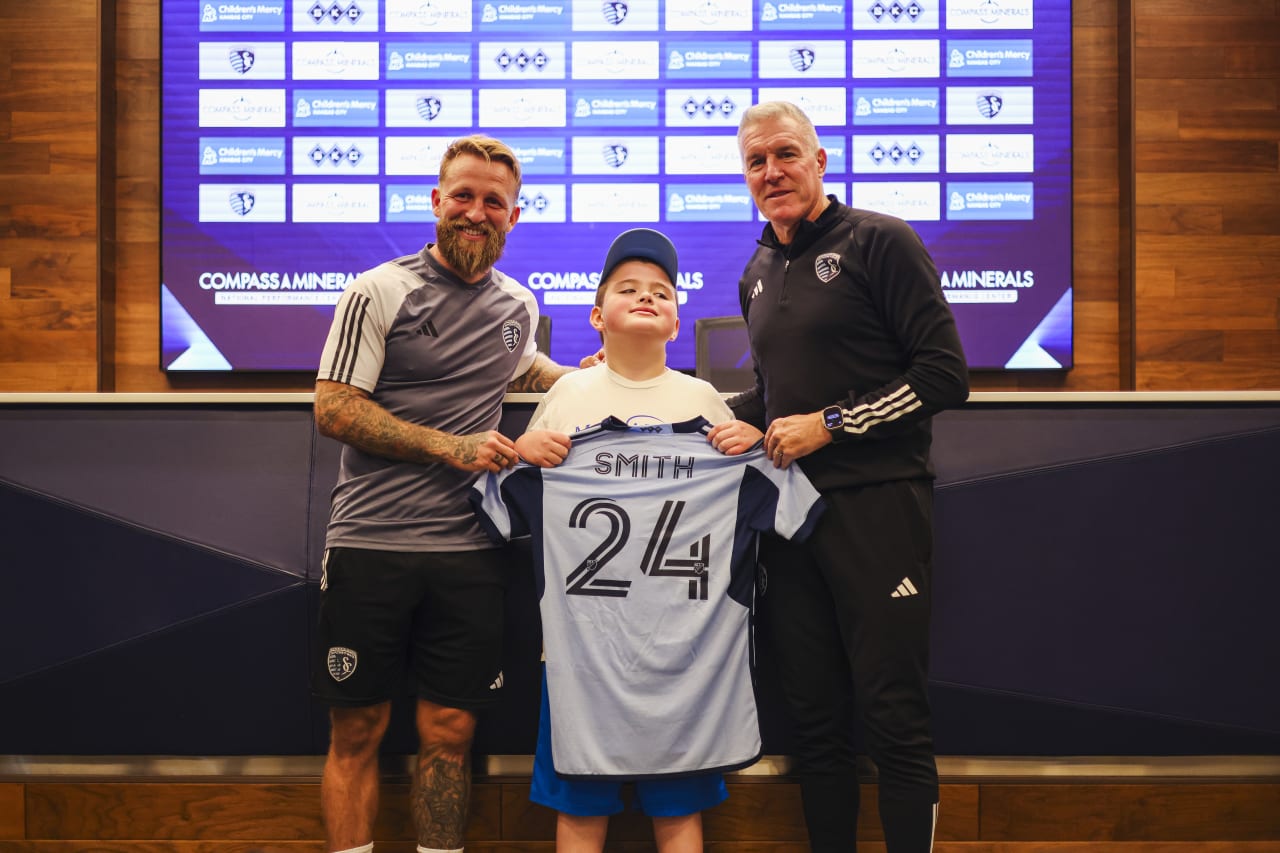 Johnny Russell, Miles Smith and Head Coach Peter Vermes take a picture in front of the media on Oct. 3..