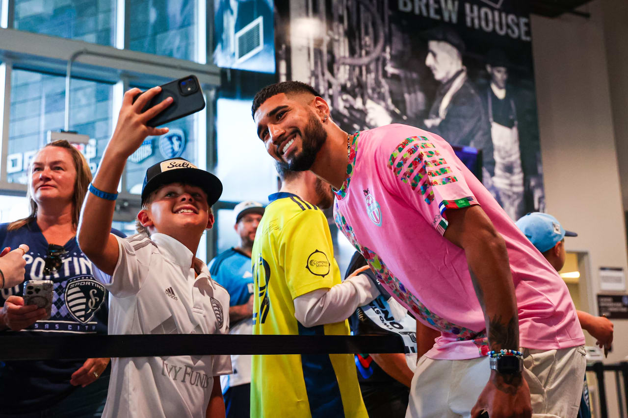 Robert Castellanos takes pictures with supporters ahead of the SKC vs CHI match.