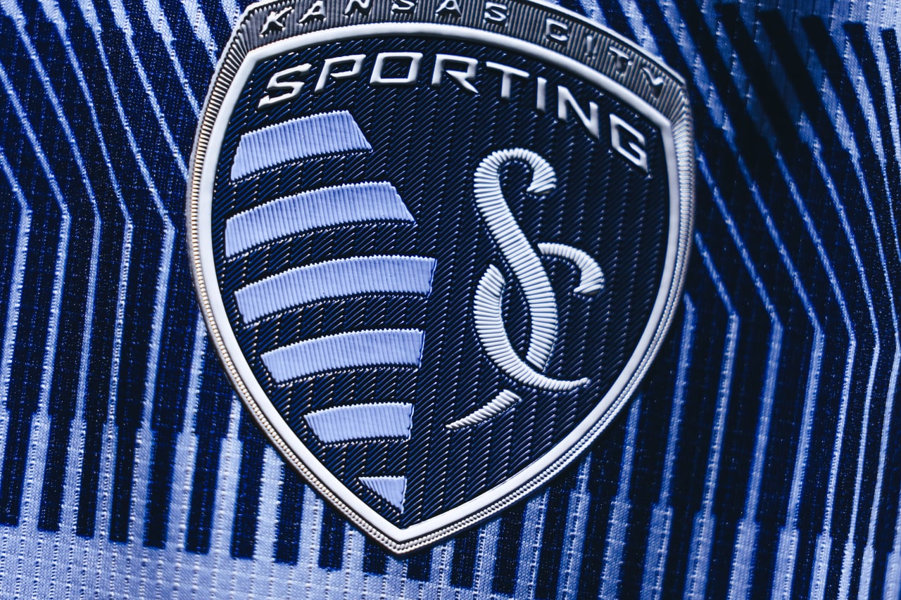 A tight photo of the Sporting KC crest on the 2025 Primary Kit.