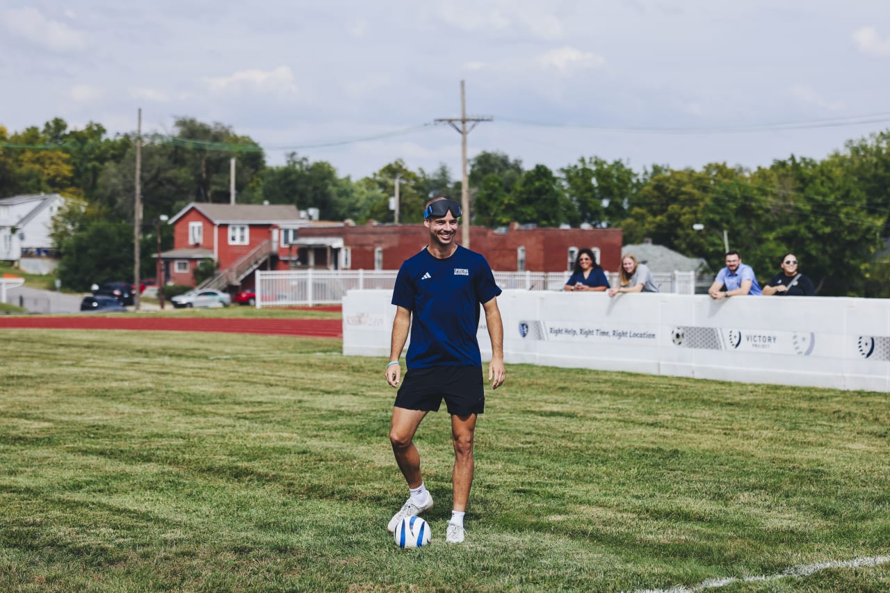 Sporting KC defender Jansen Miller laughs as he ties to learn blind soccer.