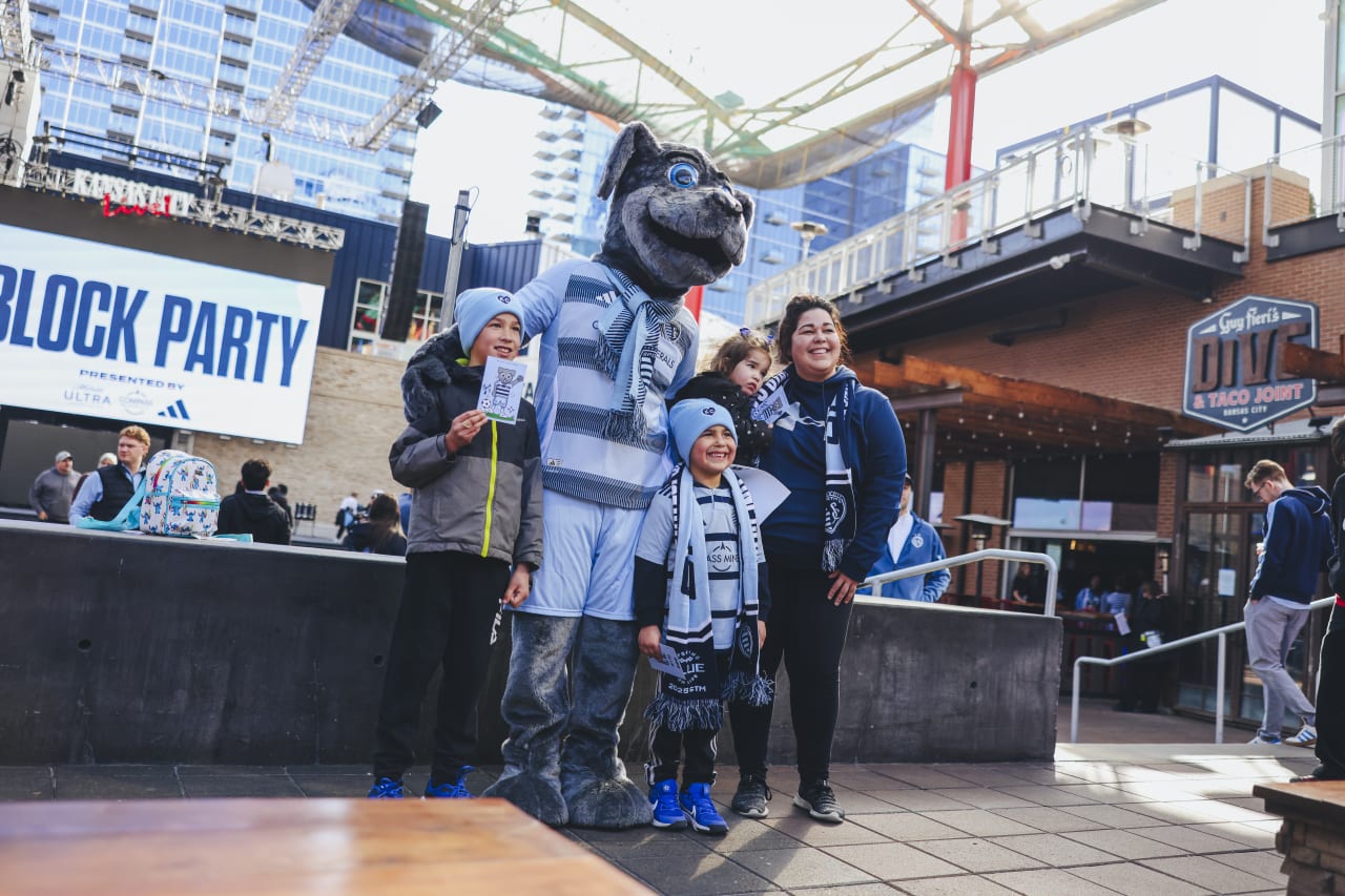 A family pauses to take a photo with Blue.