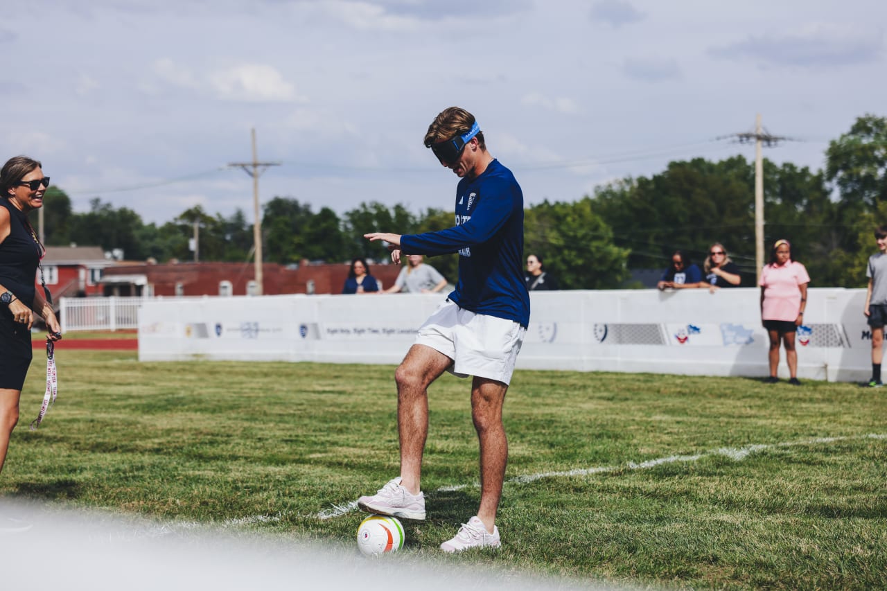 Sporting KC midfielder Jacob Bartlett dribbles the ball while blindfolded.