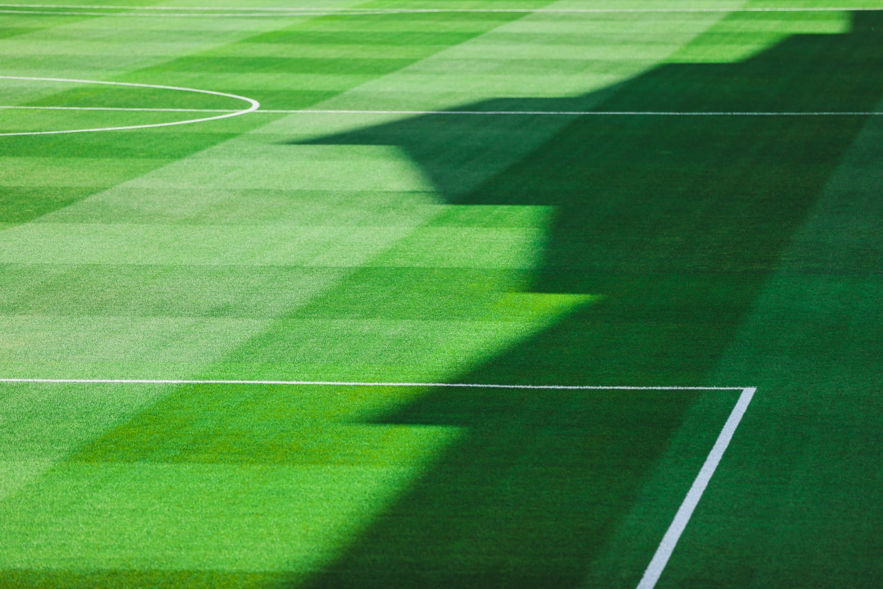 Shadows from Dick's Sporting Goods Park fall onto the field