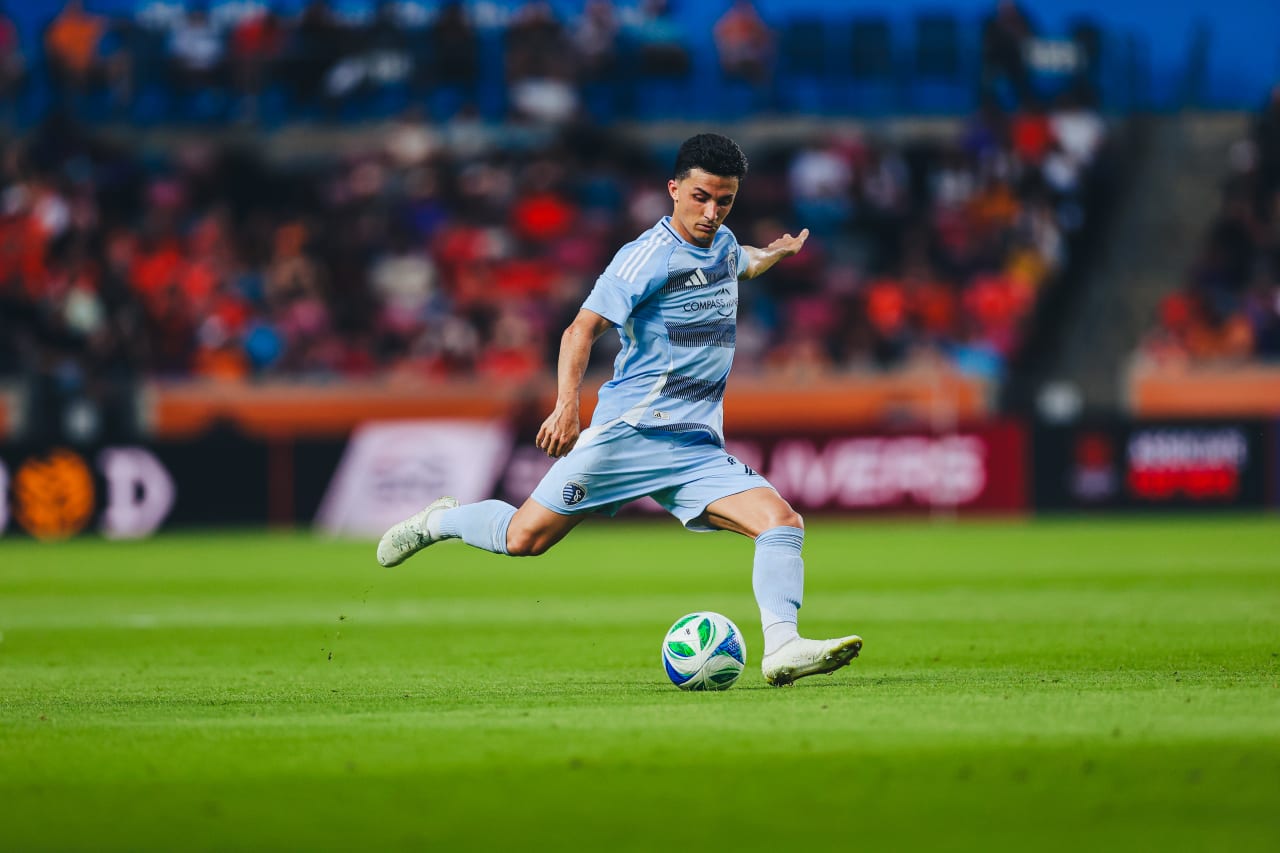 Sporting KC midfielder Manu Garcia kicks the ball during the game vs Houston