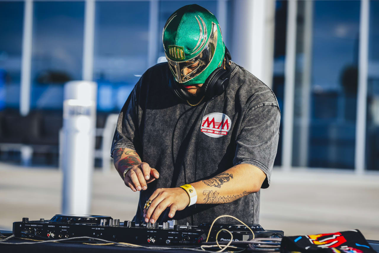 DJ FK Menace mixes before the game vs Vancouver.