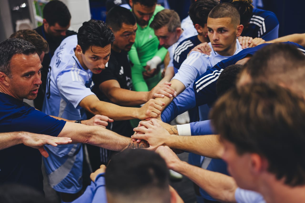 Sporting KC gathers in a team huddle in the locker room before walking out to play St. Louis
